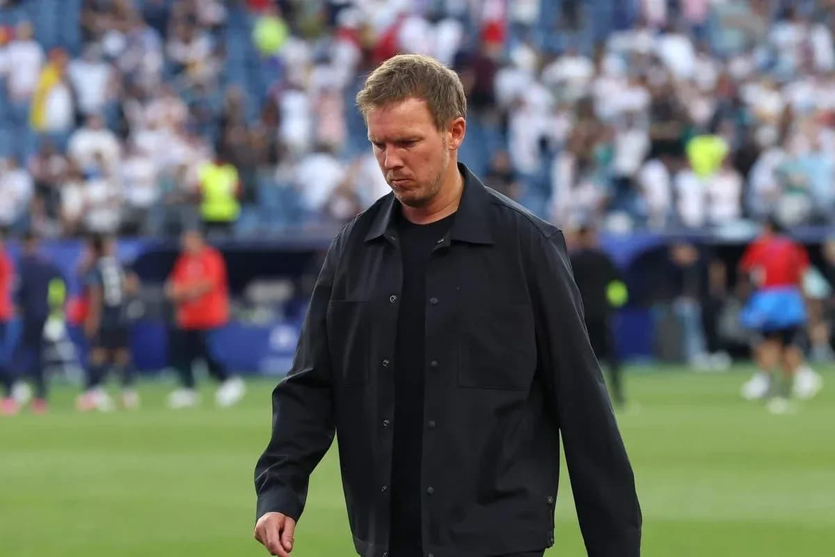 Coach walking on the pitch after the match