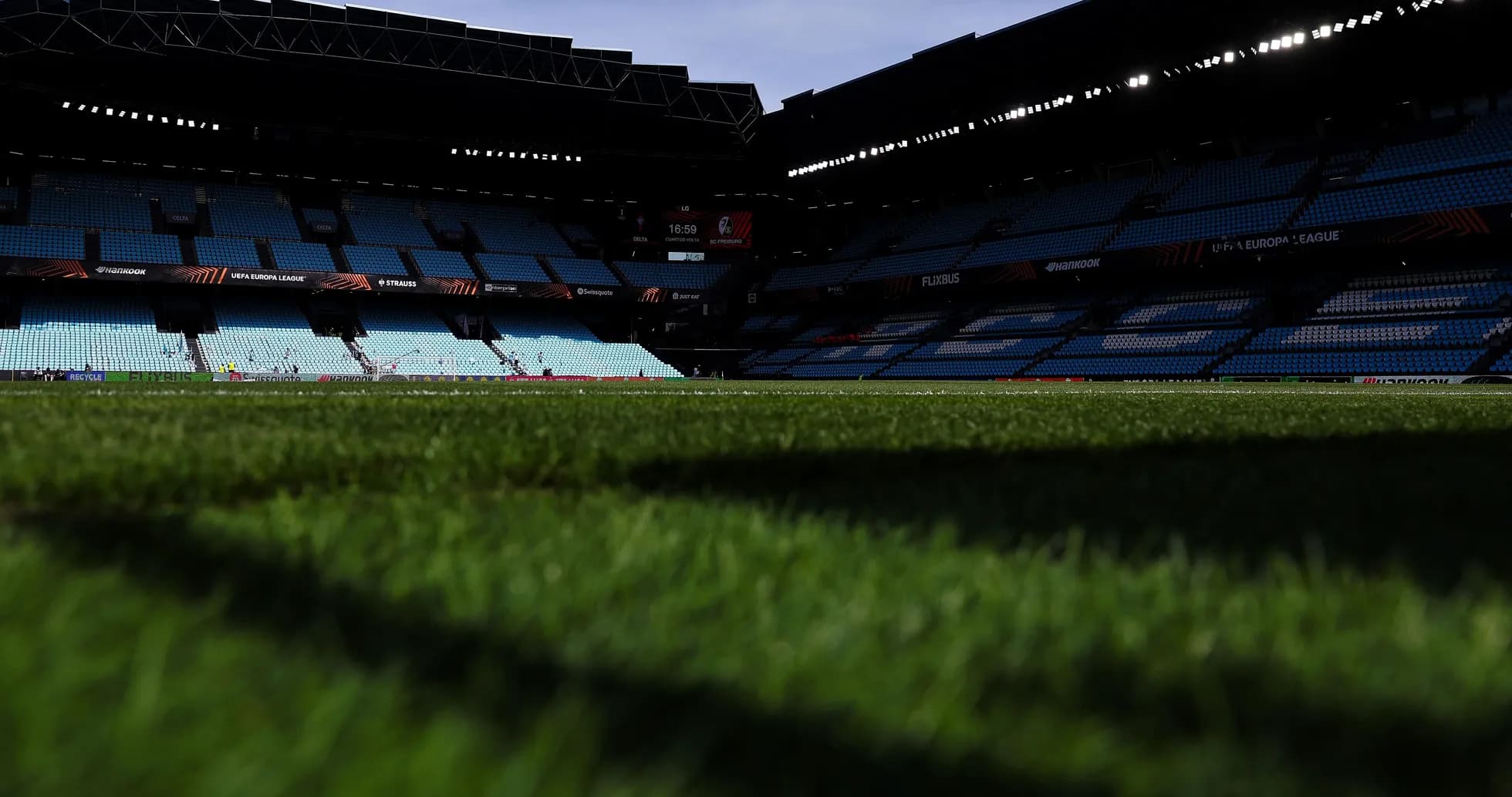 Stadium view with empty seats and grass field