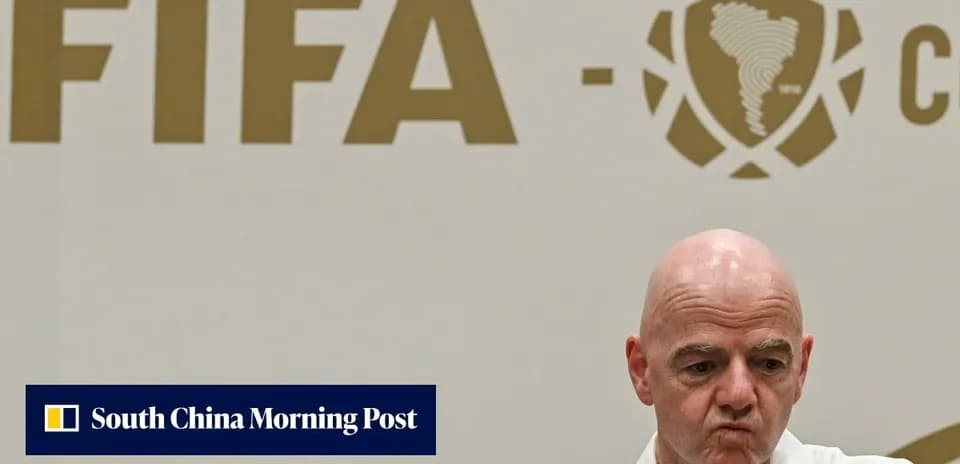 FIFA official at press conference with logo backdrop