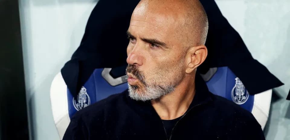 Bald coach sitting on the bench during match