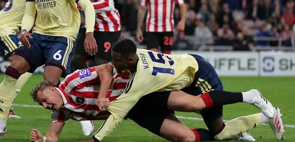 Player tackling opponent on the football pitch