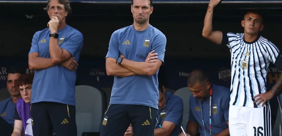 Coaches and staff observing from the bench