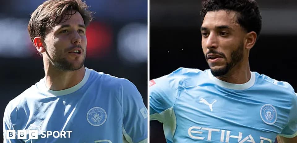 Two Manchester City players in training jerseys