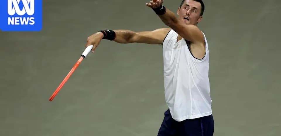 Tennis player serving during match