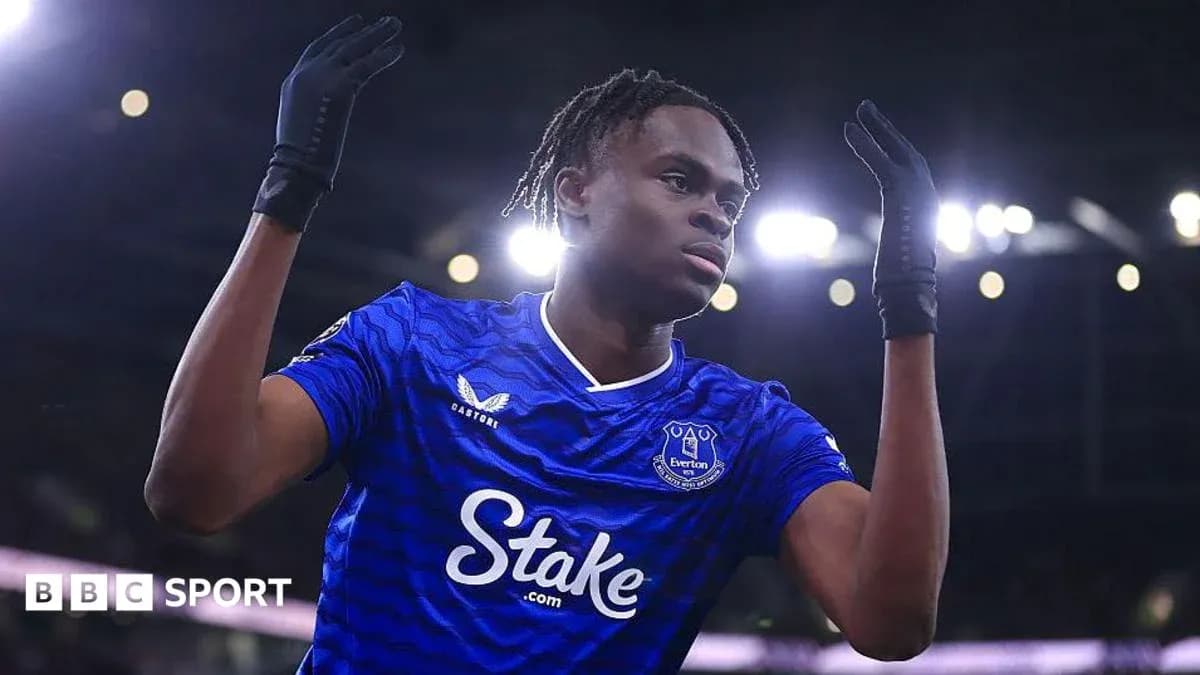 Futbolchi Everton formasida, qo'llarini ko'targan