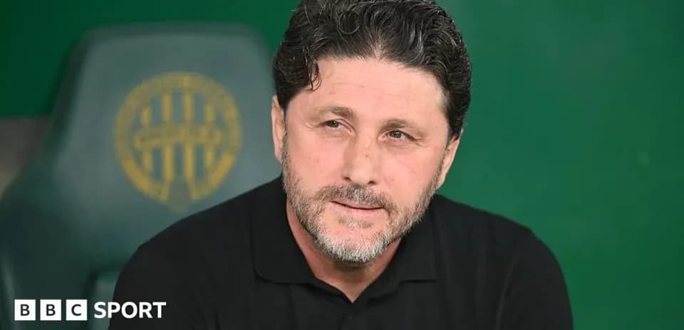 Football coach speaking during press conference
