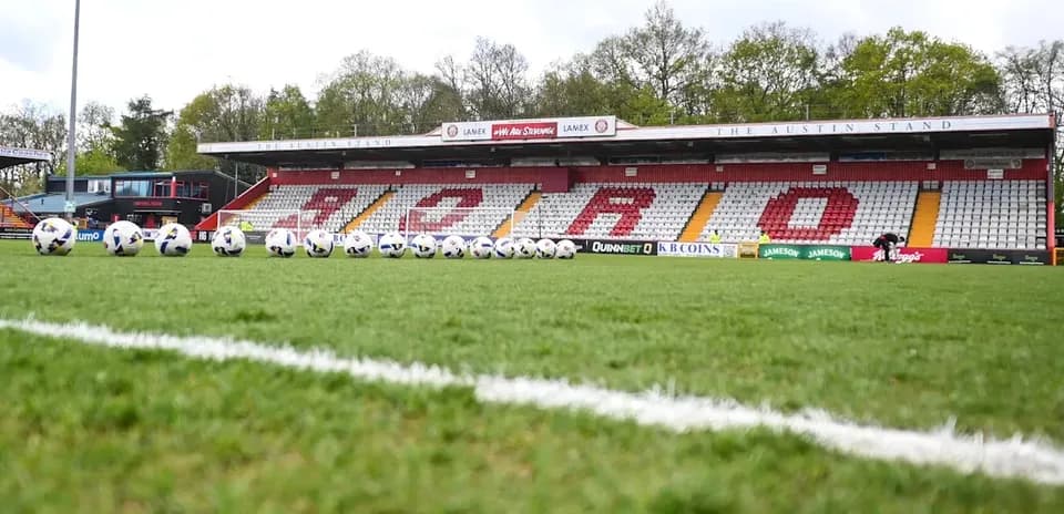 Soccer balls lined up on the pitch at stadium
