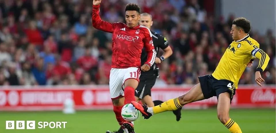 Player kicking ball during football match action