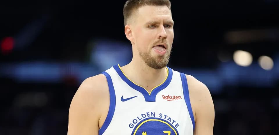 Basketball player in Golden State jersey on court