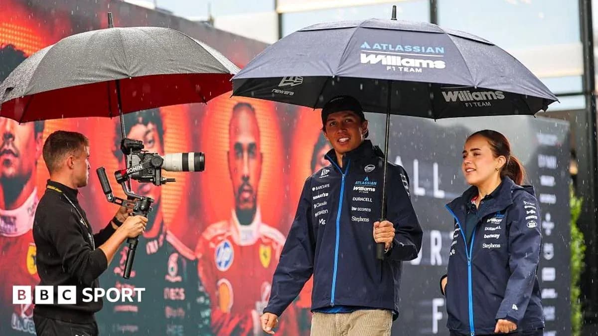 Williams F1 Team members under umbrellas during event