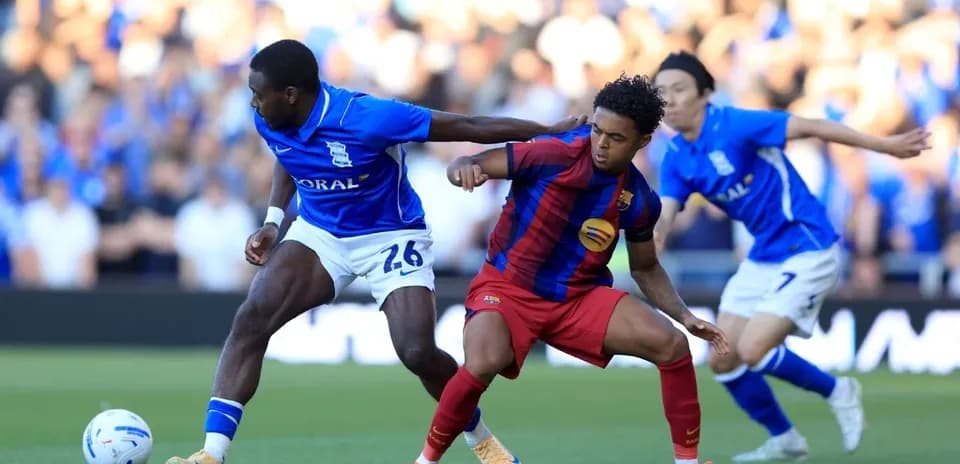 Birmingham City and Barcelona players competing for the ball
