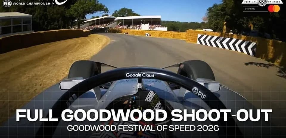 Formula E car navigating turn at Goodwood Festival