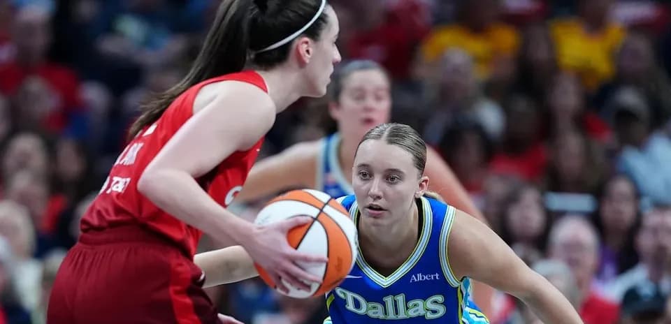 Two basketball players contesting for the ball