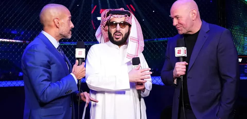 Three men speaking at UFC event with microphones