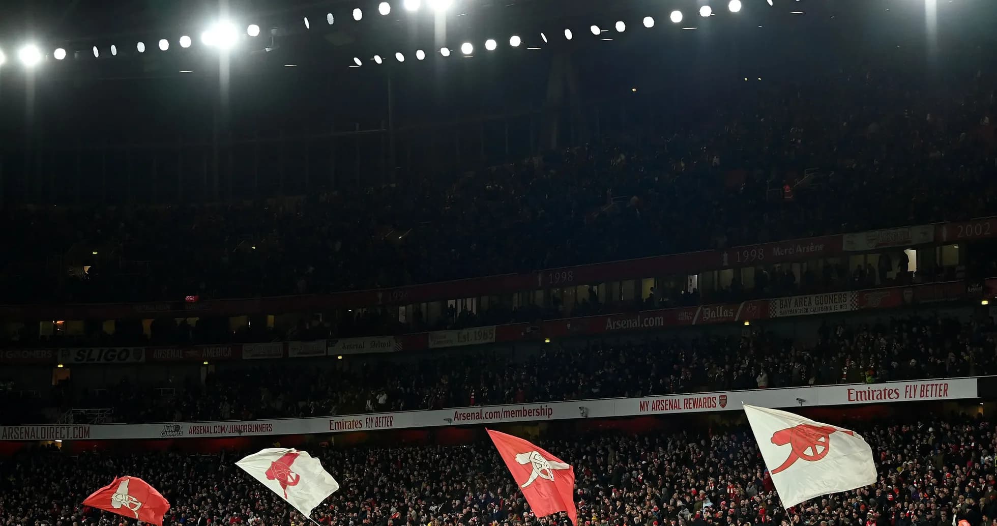 Arsenal fans waving flags at Emirates Stadium