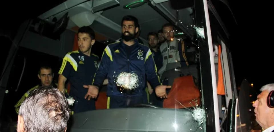 Fenerbahçe players near bus with bullet holes
