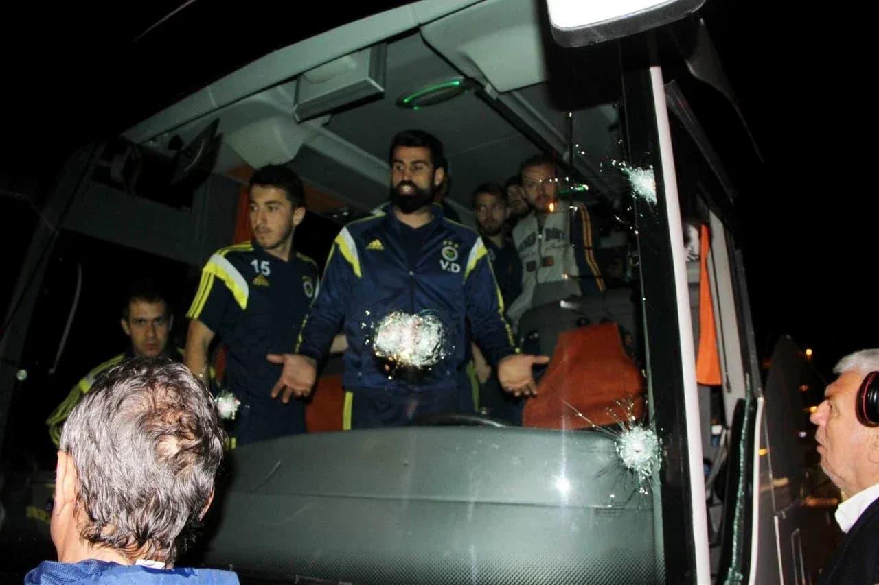 Fenerbahçe players near bus with bullet holes