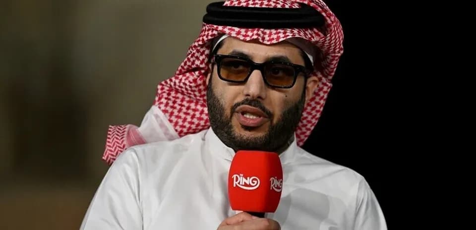 Shiekh speaking into microphone at event
