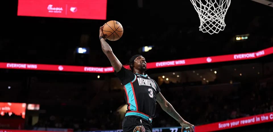 Basketball player dunking during a game