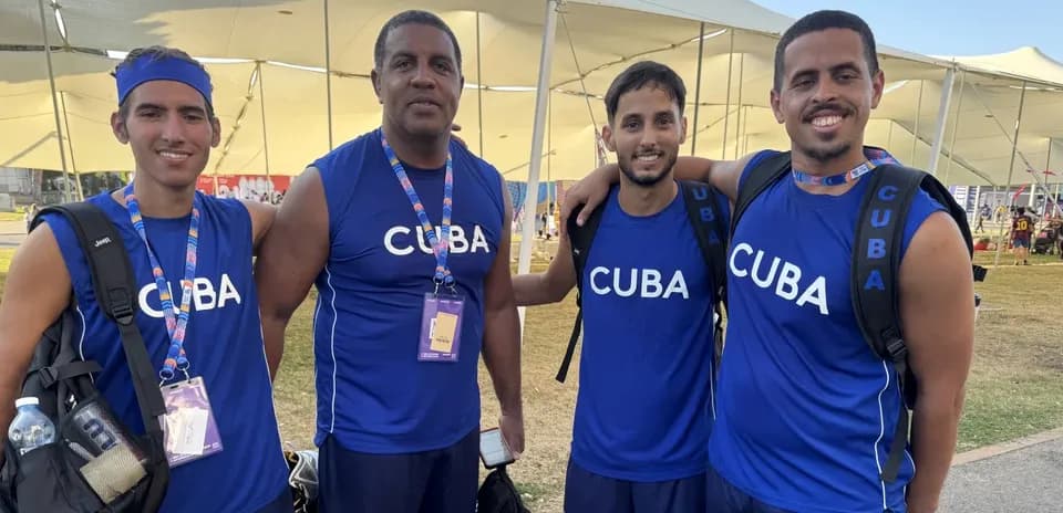 Cuban team members posing together in blue jerseys