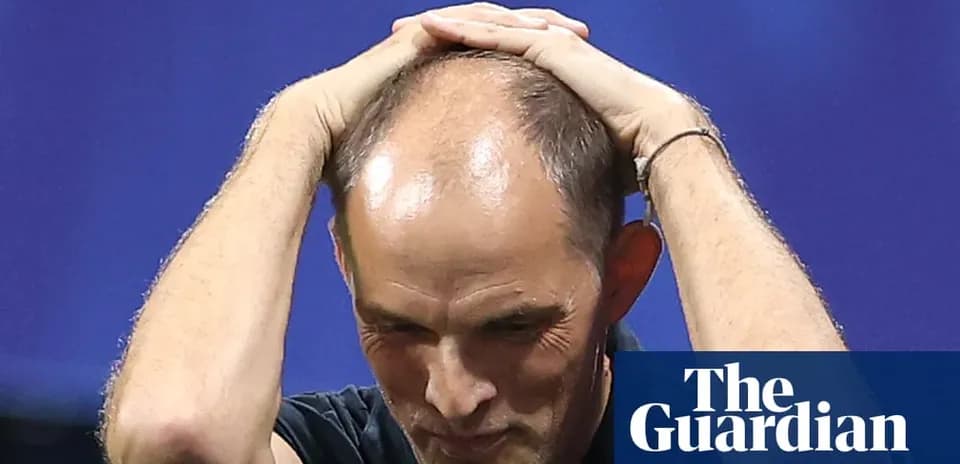 Football manager with hands on head during match