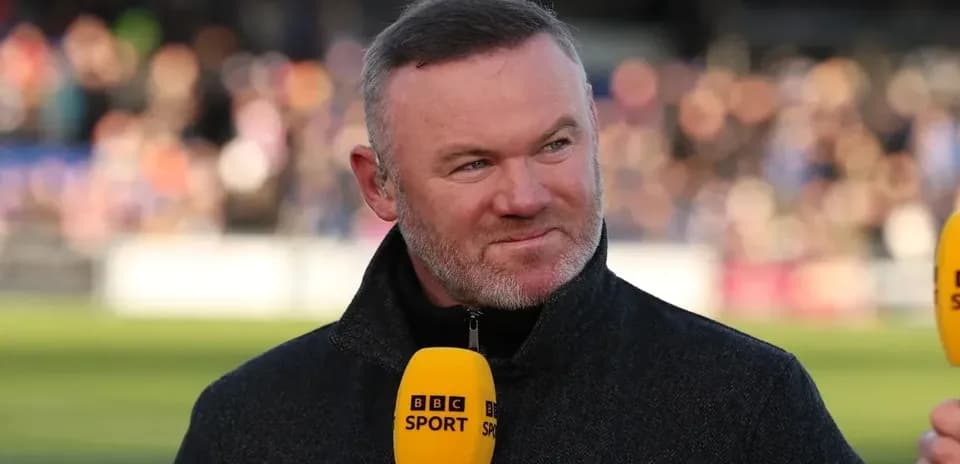 Analyst speaking into microphone during sports broadcast
