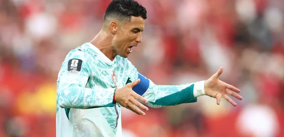 Futbolchi o'yin davomida qo'llarini ochib turibdi