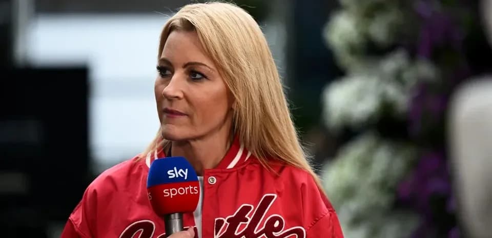 Television presenter speaking with microphone in hand