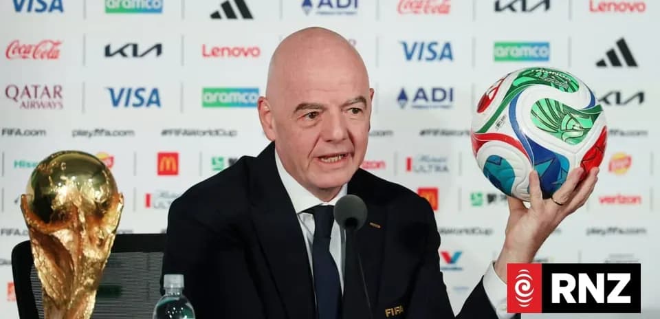 FIFA official presenting World Cup trophy and ball