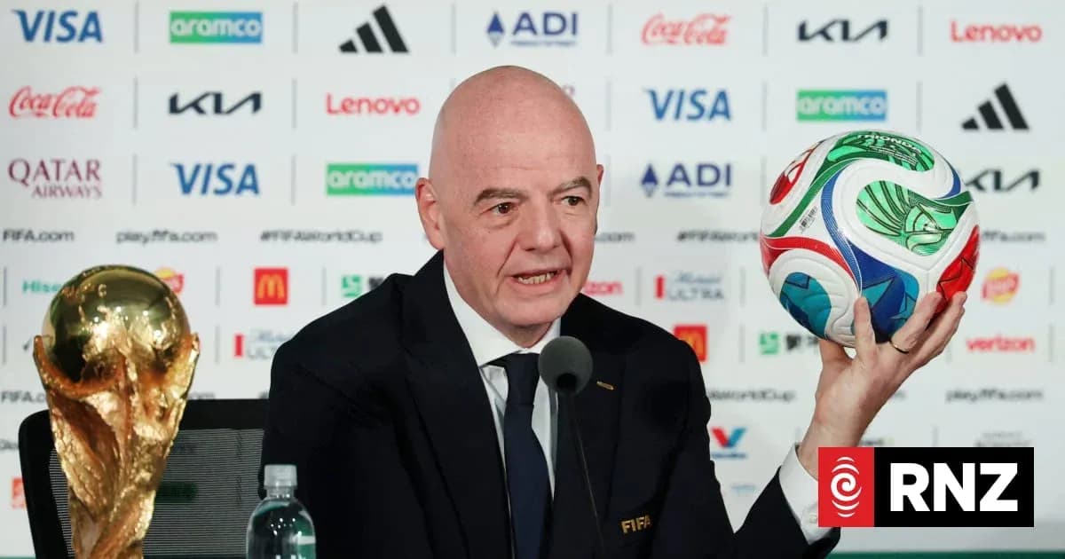 FIFA official presenting World Cup trophy and ball