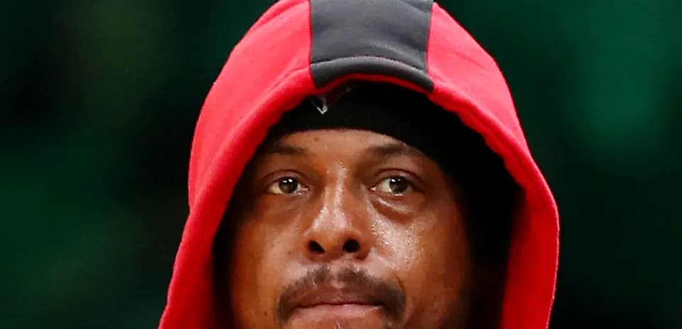 Basketball player wearing a red hoodie, focused
