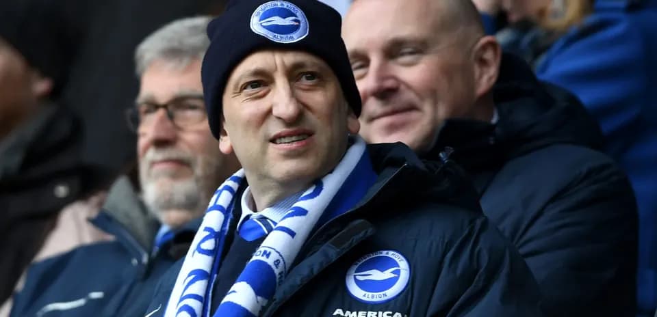Fans wearing Brighton & Hove Albion merchandise in stadium