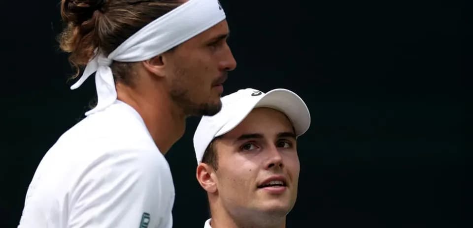 Tennis players discussing strategy during match