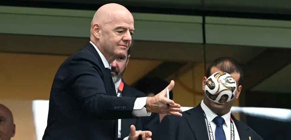 FIFA president throwing a football in a box