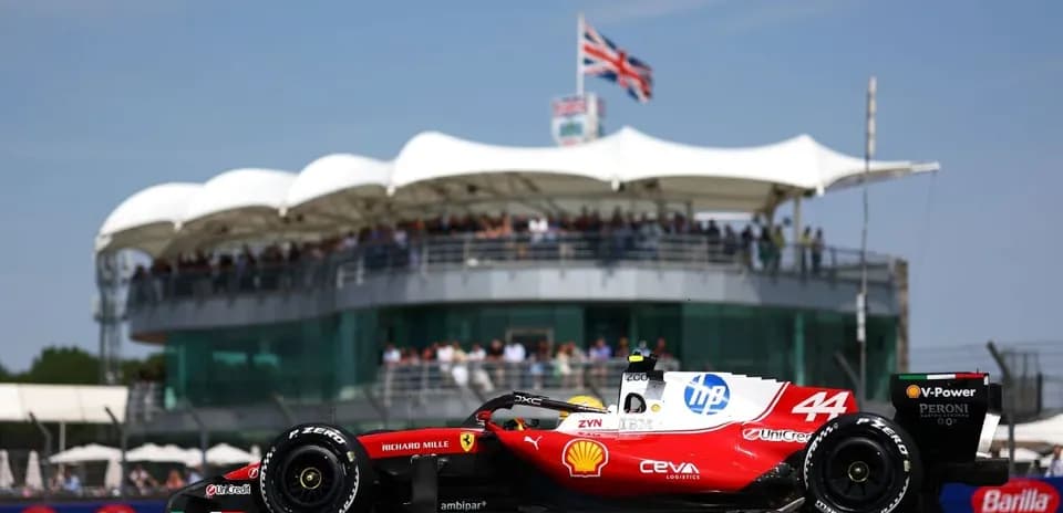 Formula 1 car racing near grandstand at circuit