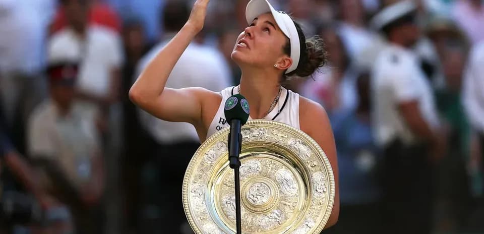 Tennis player holding trophy after winning Wimbledon