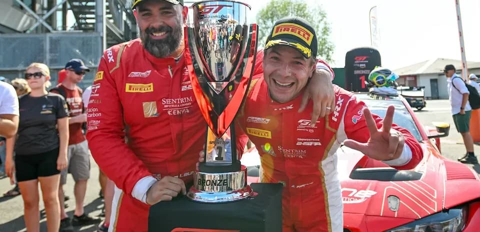 Duo celebrating with trophy after race victory
