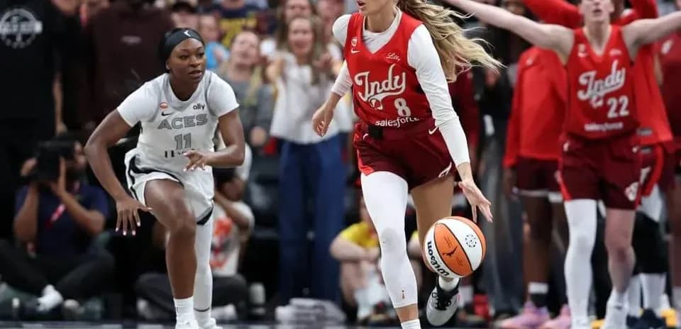 Indy player dribbling ball with opponent chasing