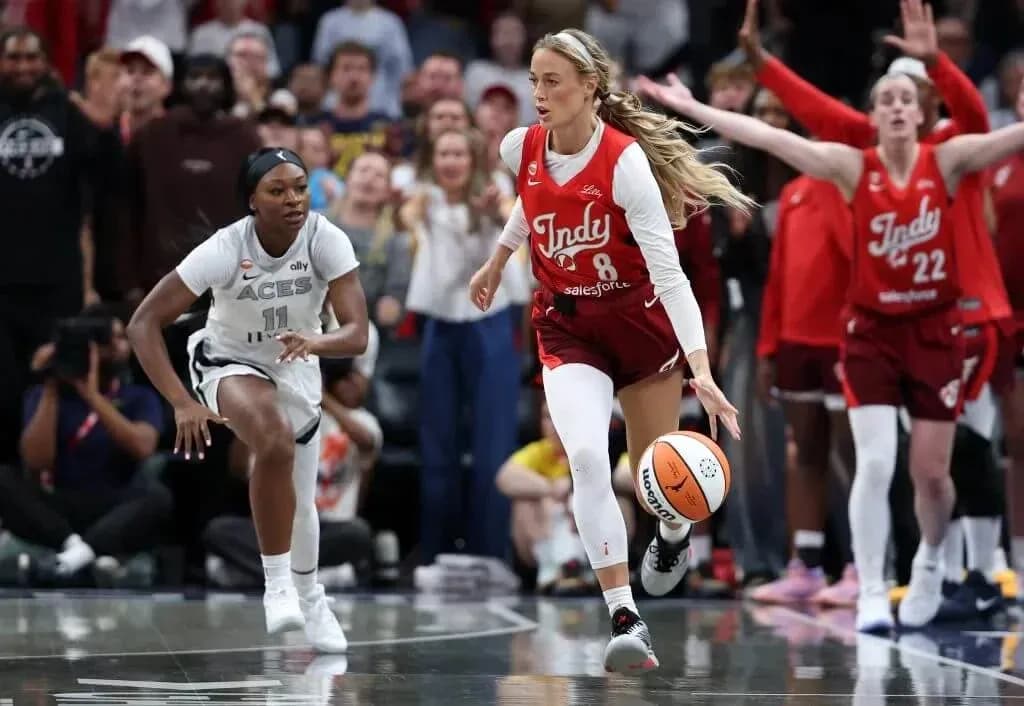 Indy player dribbling ball with opponent chasing
