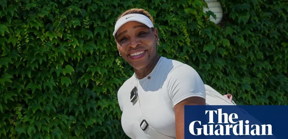 Tennis player smiling against green foliage background