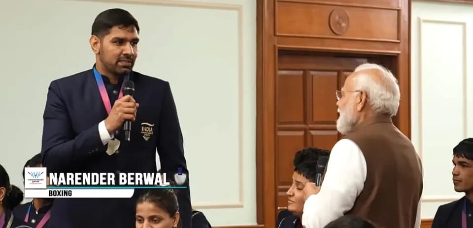 Narender Berwal speaking at event with attendees