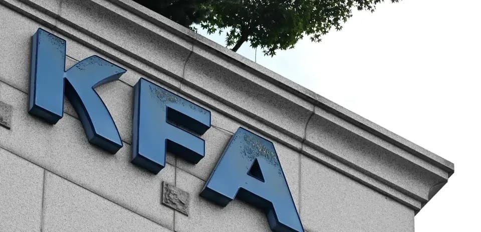 KFA sign on building exterior with trees