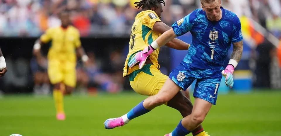 Goalkeeper colliding with opposing player during match