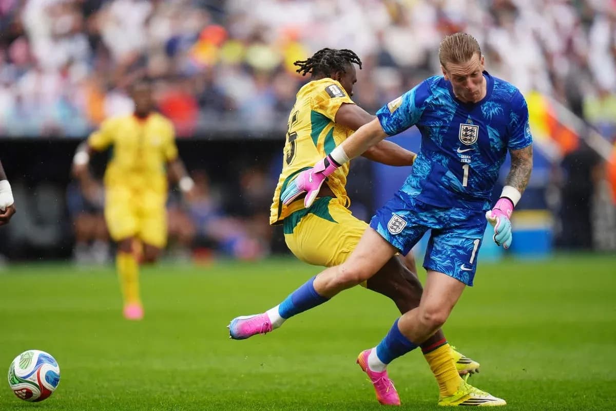 Goalkeeper colliding with opposing player during match