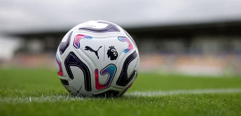 Puma Premier League football on grass pitch