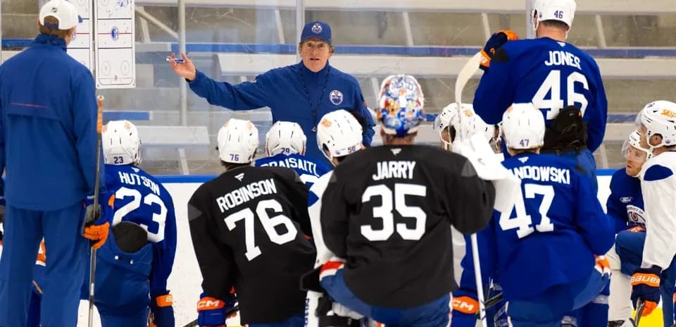 Coach instructing players during hockey practice session