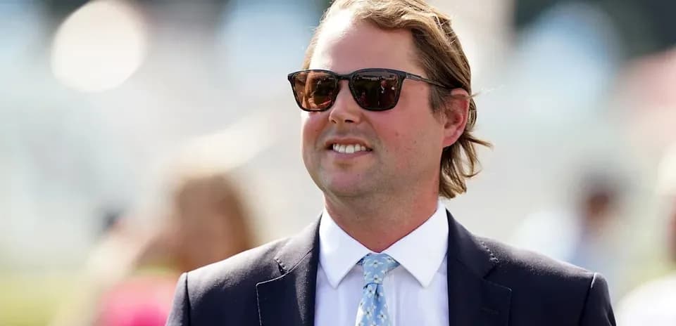 Man in sunglasses wearing a suit outdoors