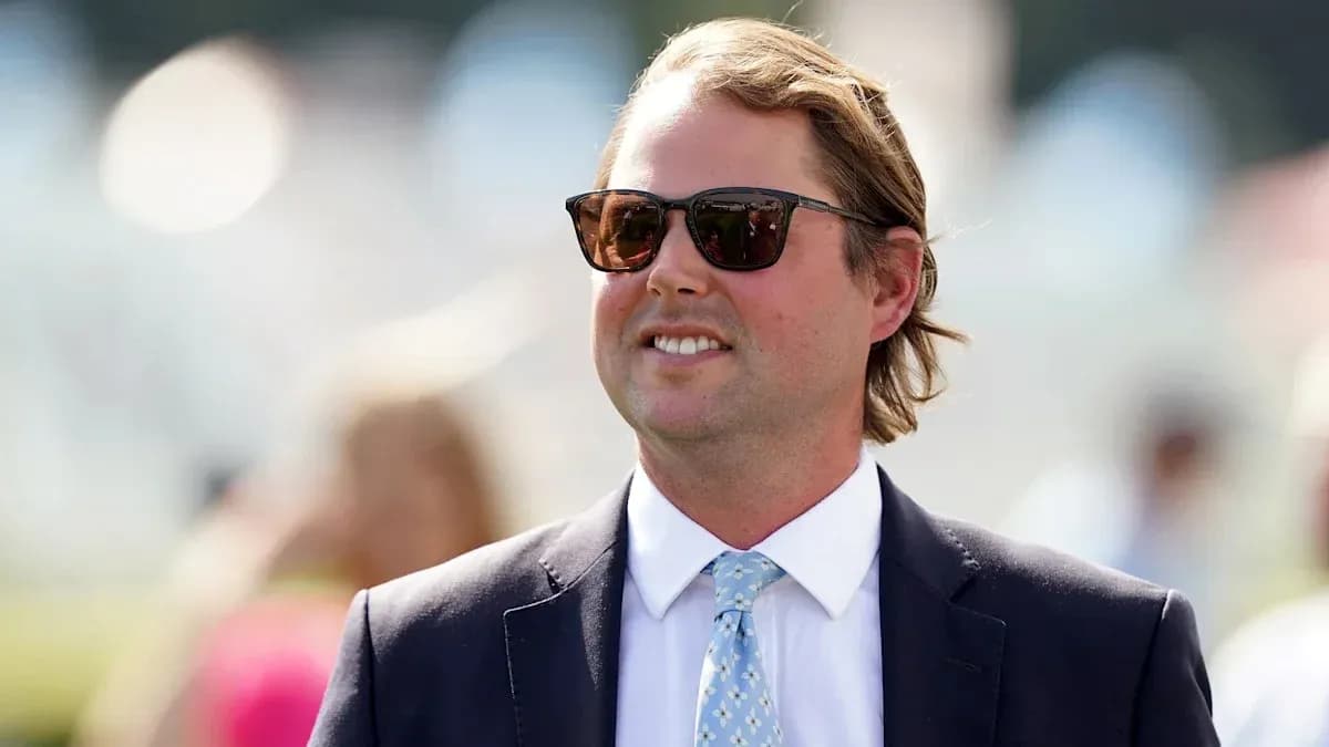 Man in sunglasses wearing a suit outdoors