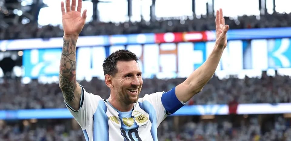 Lionel Messi waving to fans during a match