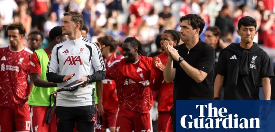 Liverpool players and staff leaving the pitch after match